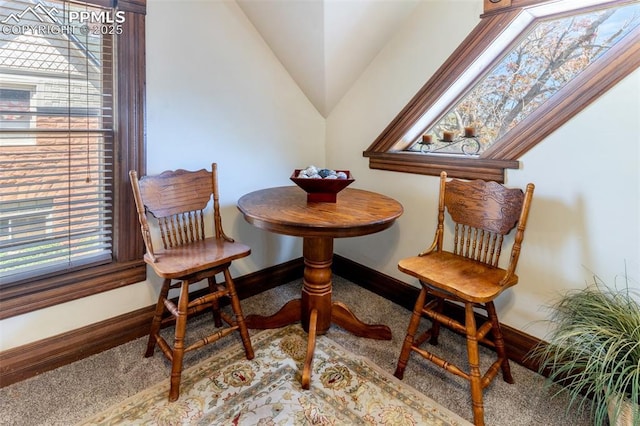 521 W Corona Ave, Pueblo, CO 81004 - carpeted dining room with vaulted ceiling and baseboards