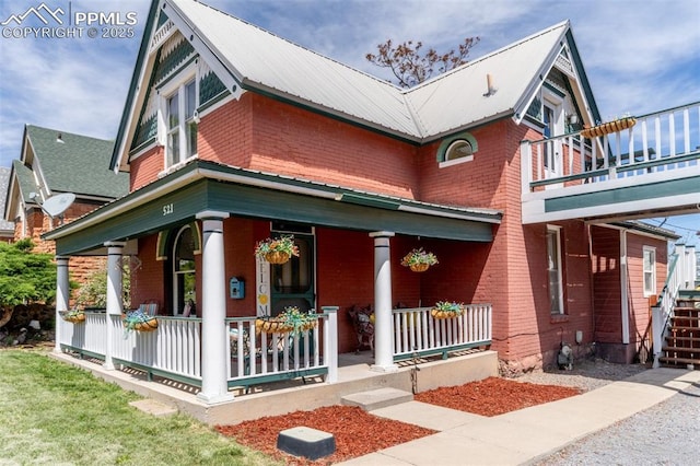 521 W Corona Ave, Pueblo, CO 81004 - view of front of home with covered porch, brick siding, and metal roof