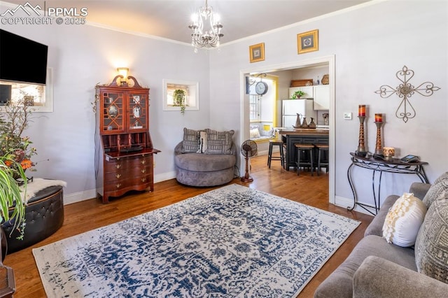 521 W Corona Ave, Pueblo, CO 81004 - living room featuring crown molding, a chandelier, wood finished floors, and baseboards