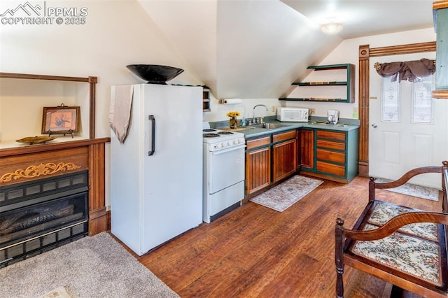 521 W Corona Ave, Pueblo, CO 81004 - kitchen featuring white appliances, a sink, lofted ceiling, dark wood-type flooring, and open shelves