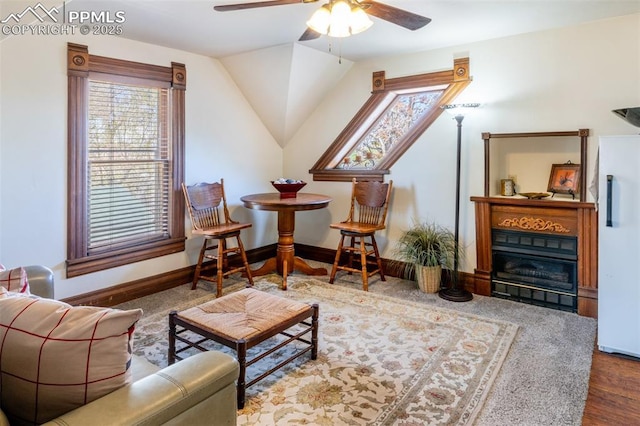 521 W Corona Ave, Pueblo, CO 81004 - living room featuring a ceiling fan, wood finished floors, baseboards, lofted ceiling, and a glass covered fireplace