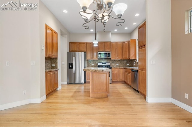 1076 Rosemary St, Denver, CO 80230 - kitchen featuring appliances with stainless steel finishes, a chandelier, light wood-style floors, decorative backsplash, and recessed lighting