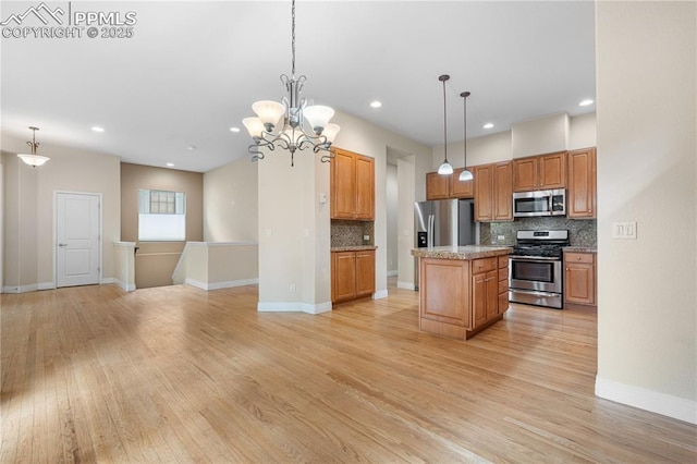 1076 Rosemary St, Denver, CO 80230 - kitchen featuring stainless steel appliances, backsplash, light wood-style flooring, hanging light fixtures, and recessed lighting
