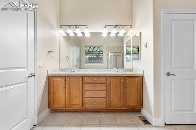 1076 Rosemary St, Denver, CO 80230 - full bathroom featuring tile patterned floors, a shower stall, baseboards, and double vanity