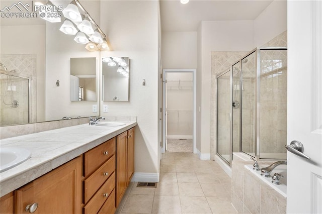 1076 Rosemary St, Denver, CO 80230 - bathroom featuring a shower stall, a spacious closet, double vanity, and tile patterned flooring