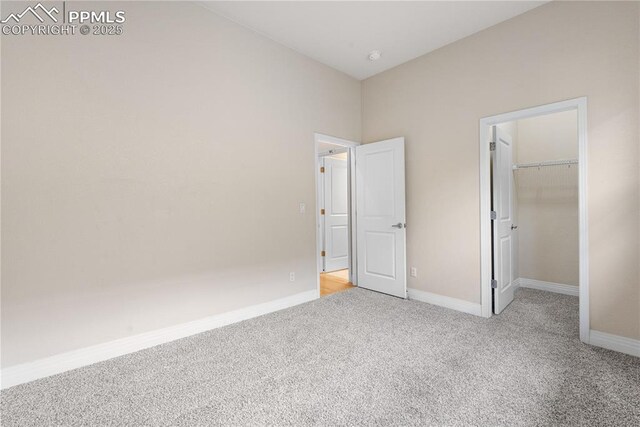 1076 Rosemary St, Denver, CO 80230 - unfurnished bedroom with carpet flooring, baseboards, a spacious closet, and a closet