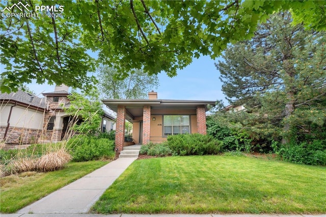 1076 Rosemary St, Denver, CO 80230 - view of front of house with a front yard, a chimney, a porch, and brick siding