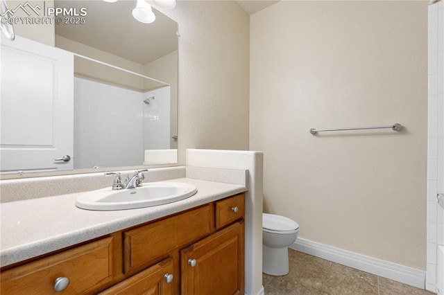 1076 Rosemary St, Denver, CO 80230 - full bathroom featuring toilet, vanity, a tile shower, baseboards, and tile patterned floors
