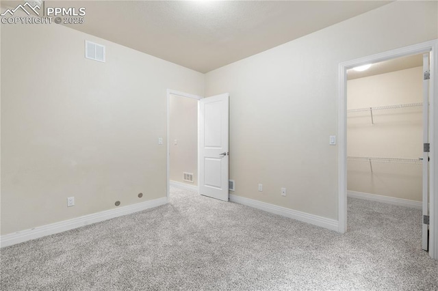 1076 Rosemary St, Denver, CO 80230 - unfurnished bedroom with carpet flooring, a spacious closet, and baseboards
