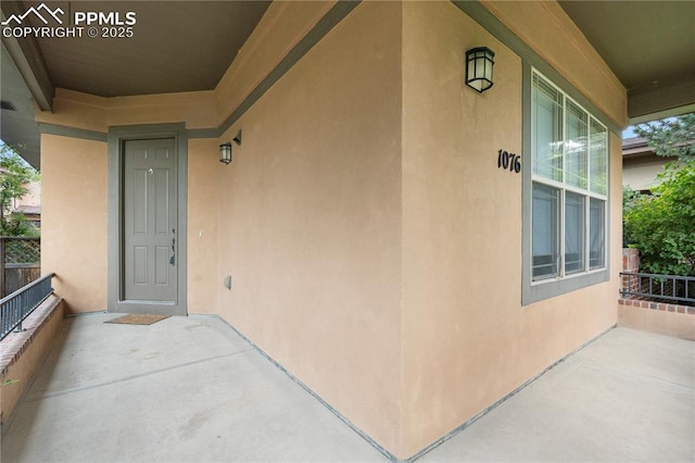 1076 Rosemary St, Denver, CO 80230 - property entrance featuring stucco siding and a porch
