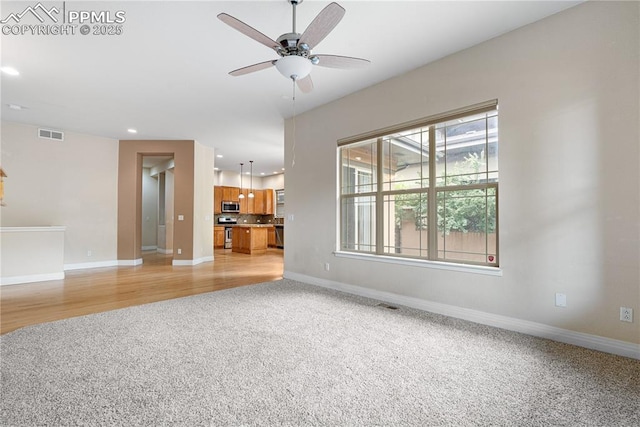 1076 Rosemary St, Denver, CO 80230 - unfurnished living room featuring light colored carpet, recessed lighting, ceiling fan, and baseboards