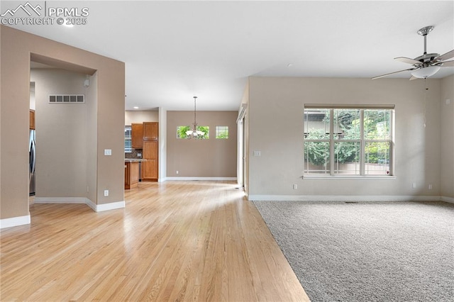 1076 Rosemary St, Denver, CO 80230 - unfurnished living room featuring healthy amount of natural light, baseboards, light wood finished floors, and a ceiling fan
