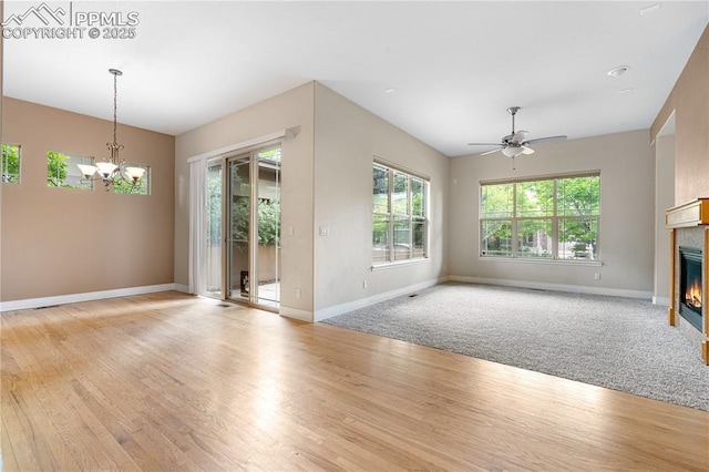 1076 Rosemary St, Denver, CO 80230 - unfurnished living room with a glass covered fireplace, plenty of natural light, a chandelier, and baseboards