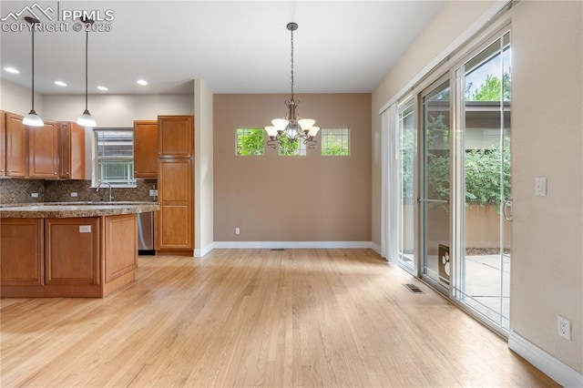1076 Rosemary St, Denver, CO 80230 - kitchen with brown cabinetry, light wood-style floors, baseboards, and recessed lighting