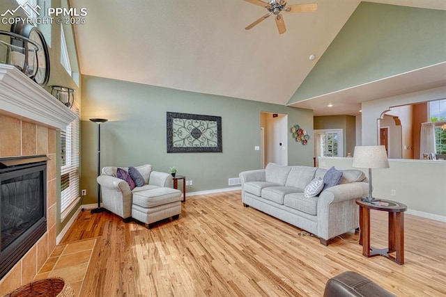 261 Saber Creek Dr, Monument, CO 80132 - living area with high vaulted ceiling, ceiling fan, baseboards, wood finished floors, and a fireplace