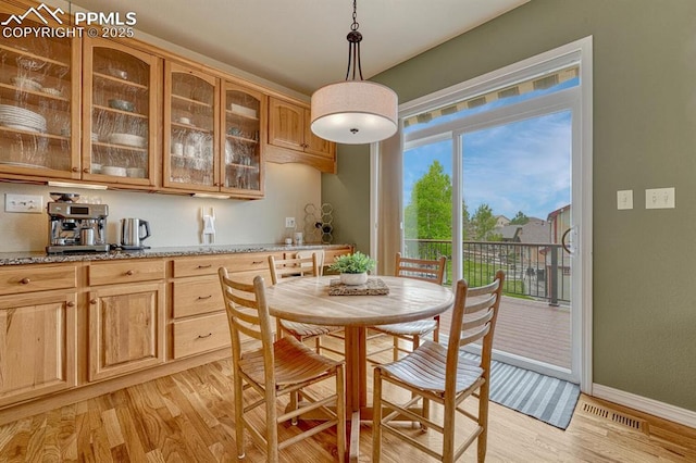 261 Saber Creek Dr, Monument, CO 80132 - dining room with light wood-style floors and baseboards