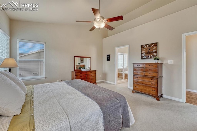 261 Saber Creek Dr, Monument, CO 80132 - bedroom with light carpet, baseboards, ensuite bathroom, ceiling fan, and a towering ceiling