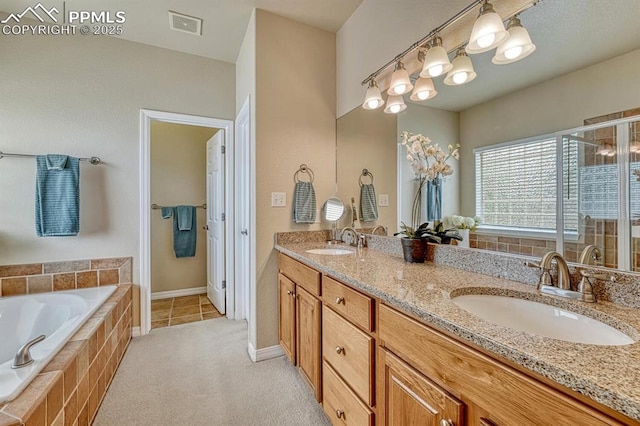 261 Saber Creek Dr, Monument, CO 80132 - bathroom featuring a garden tub, a shower stall, double vanity, tile patterned flooring, and baseboards