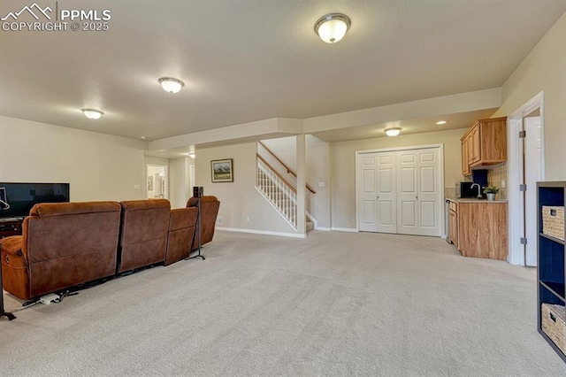 261 Saber Creek Dr, Monument, CO 80132 - living area with light carpet, stairway, and baseboards