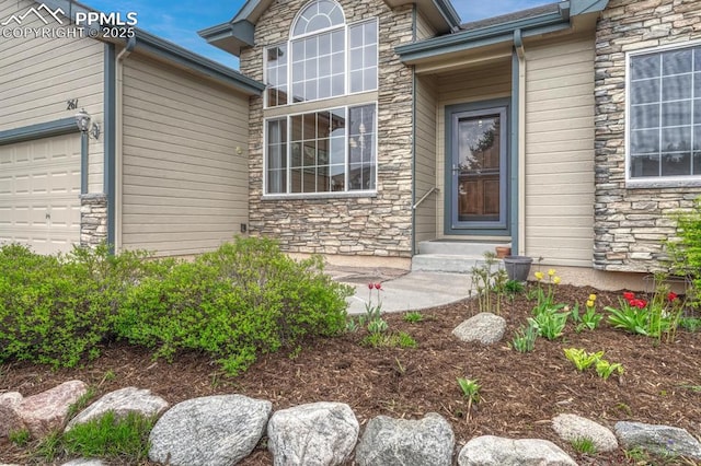 261 Saber Creek Dr, Monument, CO 80132 - view of exterior entry with stone siding and an attached garage