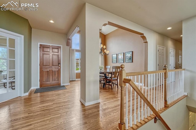 261 Saber Creek Dr, Monument, CO 80132 - entrance foyer featuring light wood finished floors, baseboards, recessed lighting, a chandelier, and arched walkways