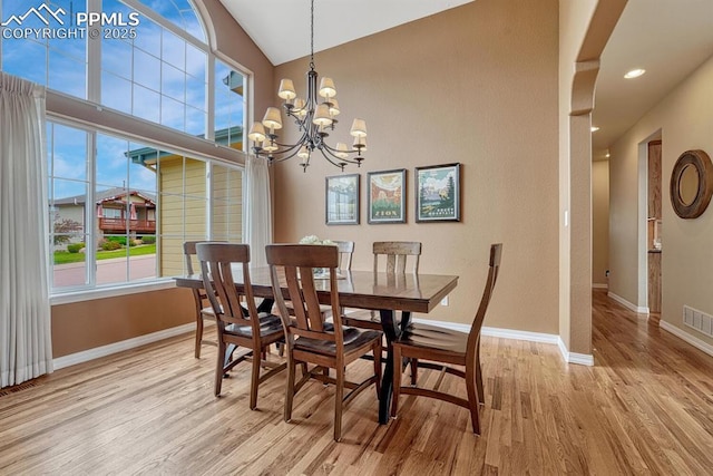 261 Saber Creek Dr, Monument, CO 80132 - dining space with wood finished floors, a chandelier, baseboards, vaulted ceiling, and recessed lighting