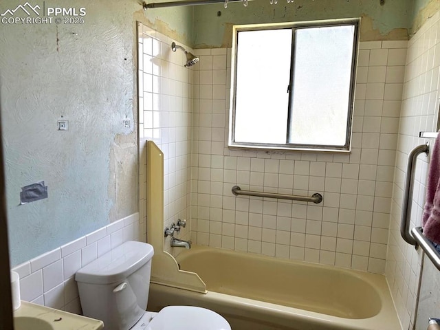 4565 Barkman Cir, Colorado Springs, CO 80916 - full bathroom with plenty of natural light, a textured wall, toilet, washtub / shower combination, and tile walls