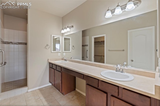 7031 Thorn Brush Way, Colorado Springs, CO 80923 - full bath featuring a tile shower, double vanity, tile patterned floors, a walk in closet, and baseboards