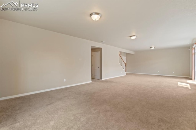 7031 Thorn Brush Way, Colorado Springs, CO 80923 - empty room featuring stairway, light colored carpet, and baseboards