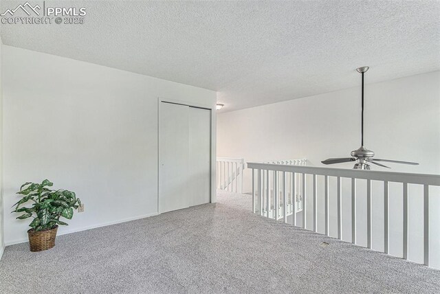 480 W Rockrimmon Blvd Unit D, Colorado Springs, CO 80919 - unfurnished room with a ceiling fan, carpet, and a textured ceiling