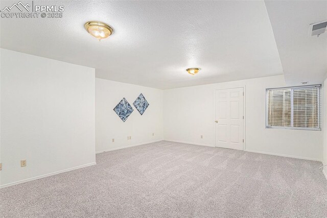 480 W Rockrimmon Blvd Unit D, Colorado Springs, CO 80919 - carpeted spare room featuring a textured ceiling and baseboards