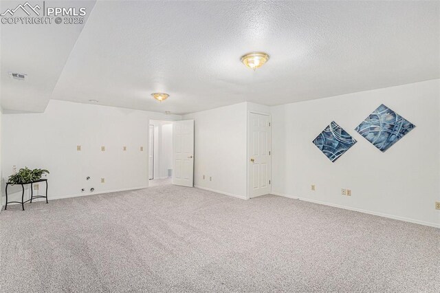 480 W Rockrimmon Blvd Unit D, Colorado Springs, CO 80919 - empty room featuring a textured ceiling, carpet flooring, and baseboards