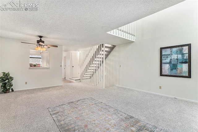 480 W Rockrimmon Blvd Unit D, Colorado Springs, CO 80919 - unfurnished living room with carpet flooring, a ceiling fan, baseboards, stairway, and a textured ceiling