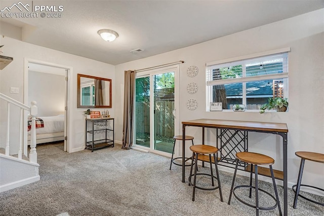 111 N 14th St, Colorado Springs, CO 80904 - carpeted dining room featuring stairway and baseboards