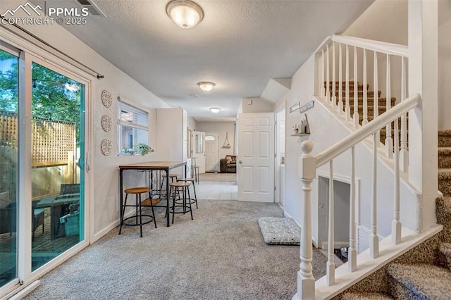 111 N 14th St, Colorado Springs, CO 80904 - entryway with carpet floors, stairway, a textured ceiling, and baseboards