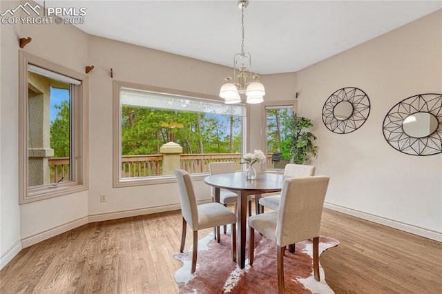 16150 Cliffrock Ct, Colorado Springs, CO 80921 - dining room featuring wood finished floors, a chandelier, and baseboards
