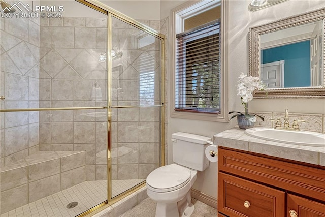 16150 Cliffrock Ct, Colorado Springs, CO 80921 - bathroom featuring a shower stall, toilet, vanity, and baseboards