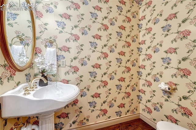 16150 Cliffrock Ct, Colorado Springs, CO 80921 - half bathroom featuring baseboards, wood finished floors, wallpapered walls, and toilet