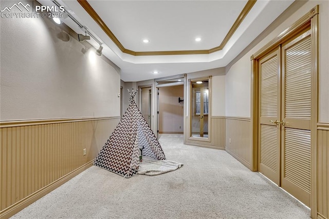 16150 Cliffrock Ct, Colorado Springs, CO 80921 - recreation room featuring ornamental molding, a wainscoted wall, carpet, a tray ceiling, and recessed lighting