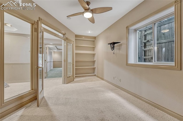 16150 Cliffrock Ct, Colorado Springs, CO 80921 - empty room with french doors, carpet flooring, a ceiling fan, baseboards, and healthy amount of natural light