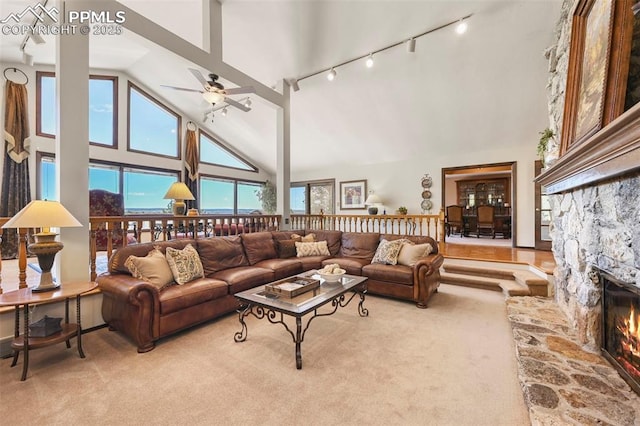 8020 Westwood Rd, Colorado Springs, CO 80919 - living room featuring high vaulted ceiling, carpet floors, a ceiling fan, rail lighting, and a fireplace