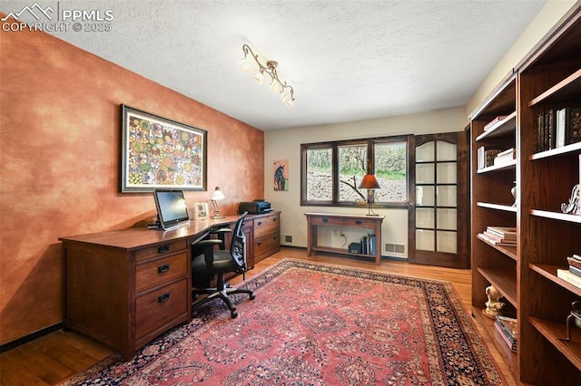 8020 Westwood Rd, Colorado Springs, CO 80919 - office space featuring wood finished floors and a textured ceiling