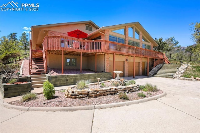 8020 Westwood Rd, Colorado Springs, CO 80919 - view of front of house with stairway, concrete driveway, a garage, and a wooden deck