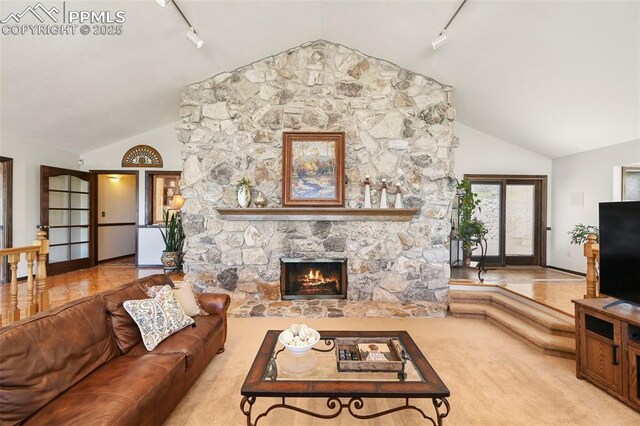 8020 Westwood Rd, Colorado Springs, CO 80919 - living room with track lighting, a fireplace, and high vaulted ceiling