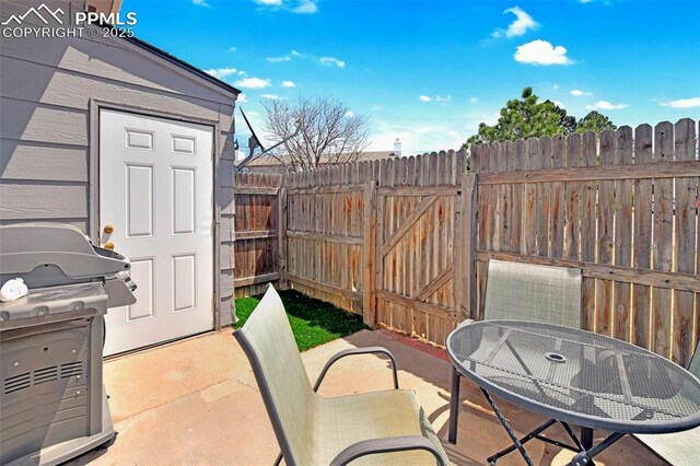1234 Soaring Eagle Dr, Colorado Springs, CO 80915 - view of patio with fence, a grill, and outdoor dining area