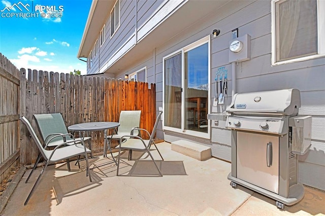 1234 Soaring Eagle Dr, Colorado Springs, CO 80915 - view of patio / terrace with grilling area, outdoor dining space, and fence