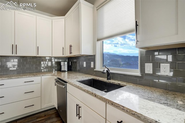 2062 Lone Willow Vw, Colorado Springs, CO 80904 - kitchen with a sink, stainless steel dishwasher, and white cabinets