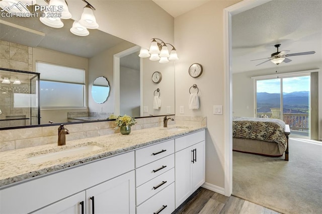 2062 Lone Willow Vw, Colorado Springs, CO 80904 - full bathroom featuring double vanity, ensuite bathroom, ceiling fan, a shower stall, and a mountain view