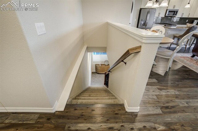 2062 Lone Willow Vw, Colorado Springs, CO 80904 - stairway with wood finished floors and baseboards