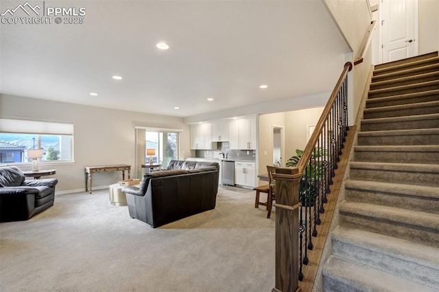 2062 Lone Willow Vw, Colorado Springs, CO 80904 - living area with light colored carpet, stairs, plenty of natural light, and recessed lighting